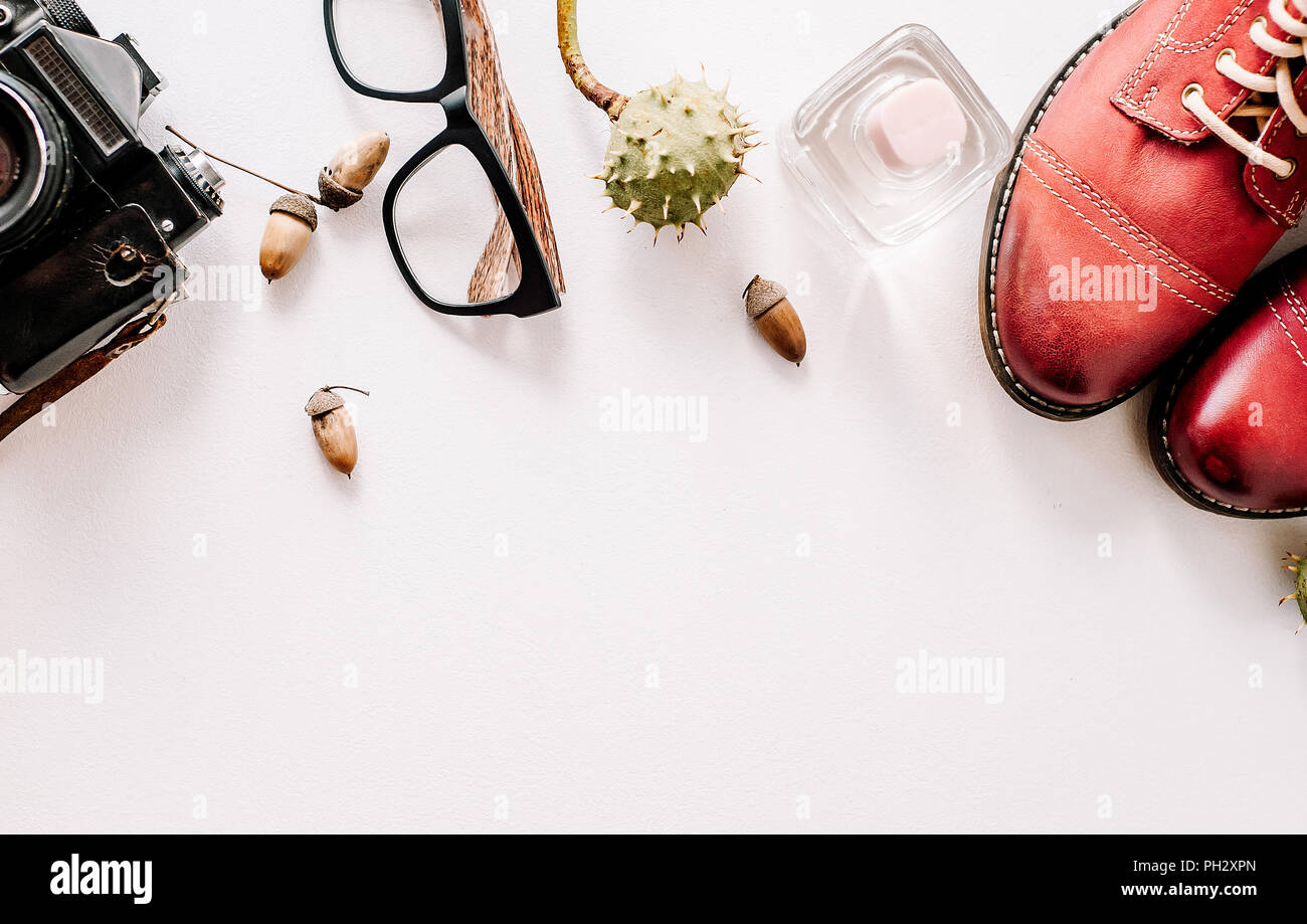 red boots lie with the camera, glasses and acorns. Stock Photo
