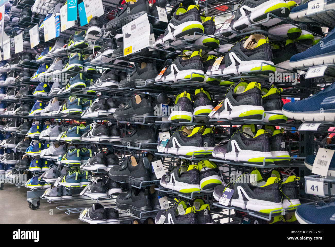 Row of trainers, sneakers on display in a decathlon shop, uk Stock Photo -  Alamy