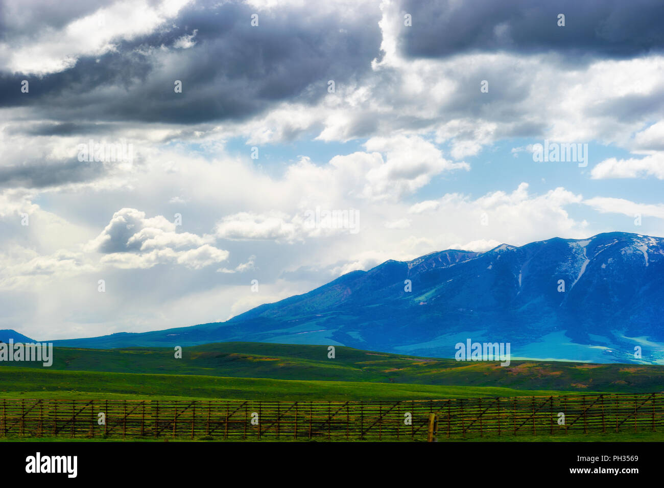 Views of Wyoming's ominous cloudy skies over open fields and sections of the Laramie Mountain Range, seen from highway 80 Stock Photo