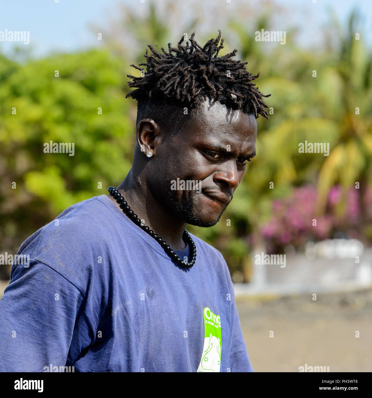 ORANGO ISLAND, GUINEA BISSAU - MAY 3, 2017: Unidentified local man with braids looks down on the Orango Island, Guinea Bissau Stock Photo