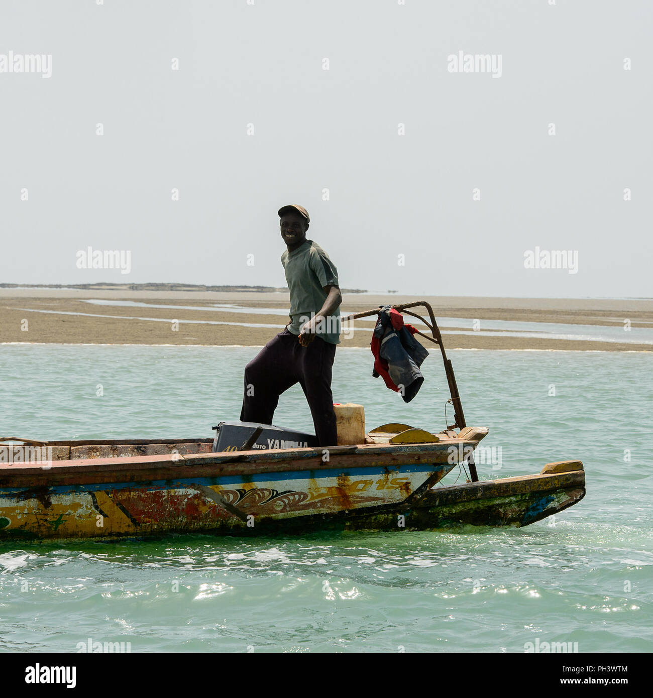 ORANGO ISLAND, GUINEA BISSAU - MAY 3, 2017: Unidentified local man sails in a boat on the Orango Island, Guinea Bissau Stock Photo