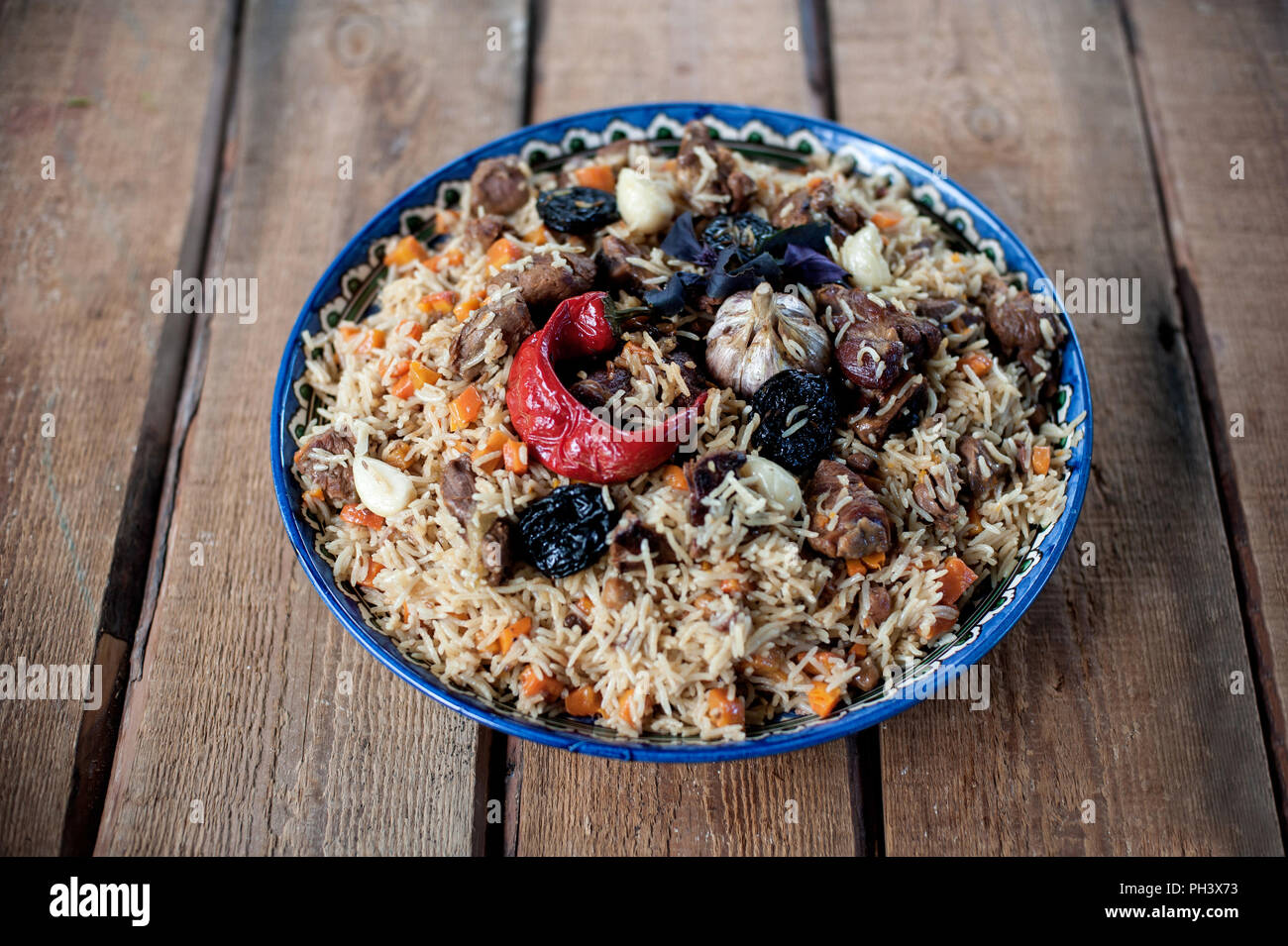 Basmati rice pilaf with pepper, onion prunes, garlic and beef Stock Photo