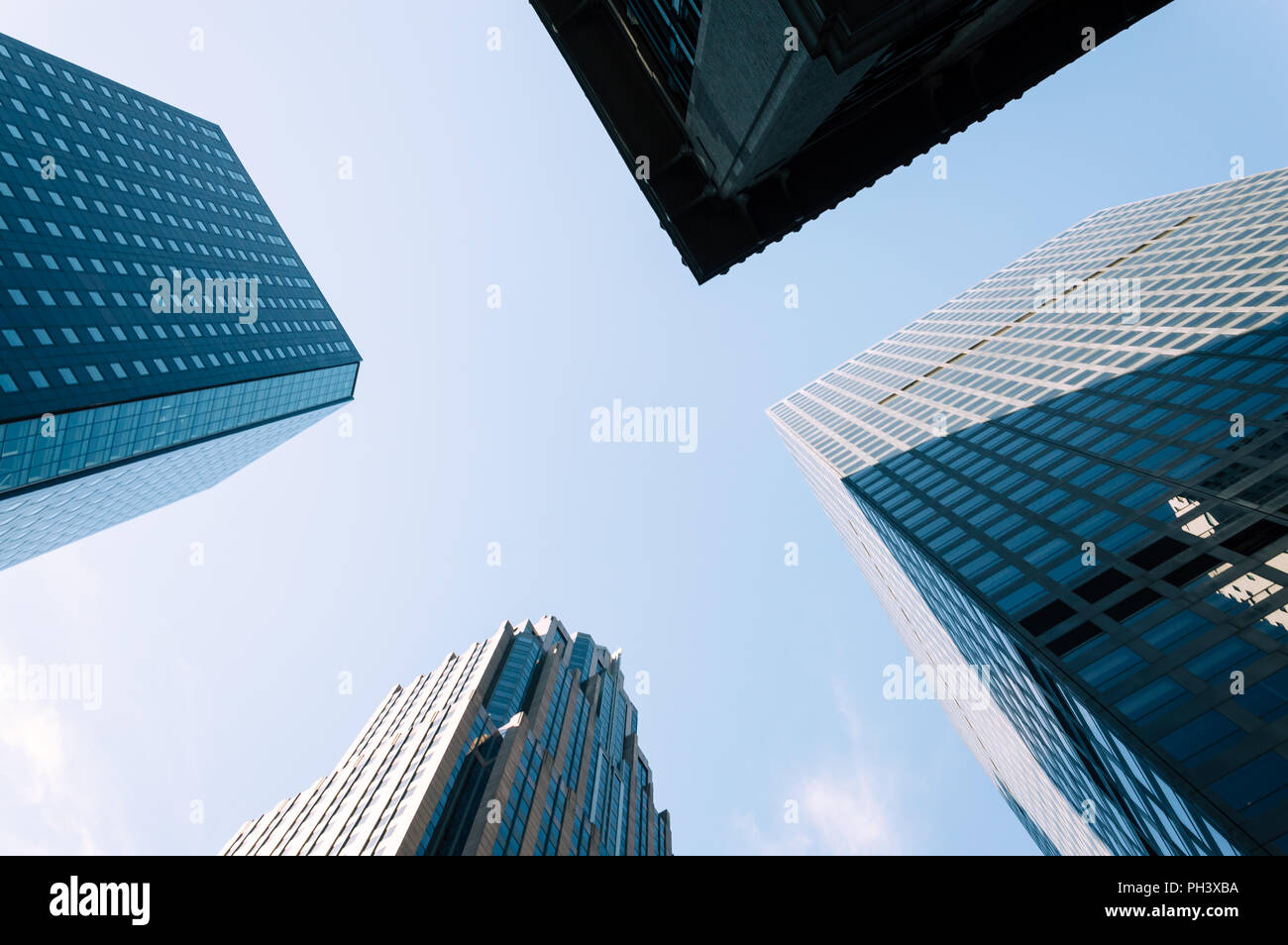 Low angle view of skyscrapers against blue sky in Nerw York with space for copy, Directly below view Stock Photo