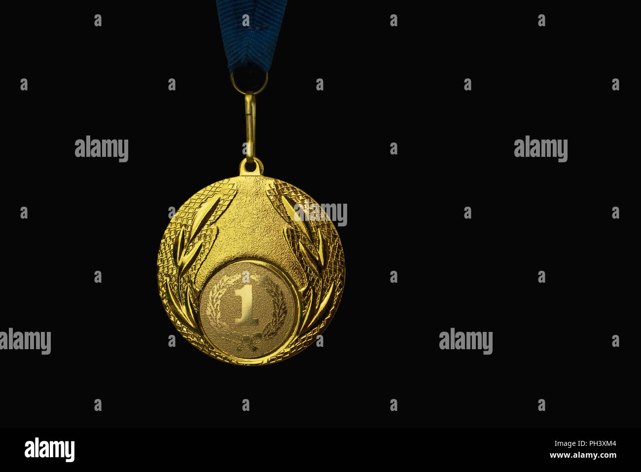 the winner's gold medal for the first place. Isolated on a black background. place for text. Stock Photo