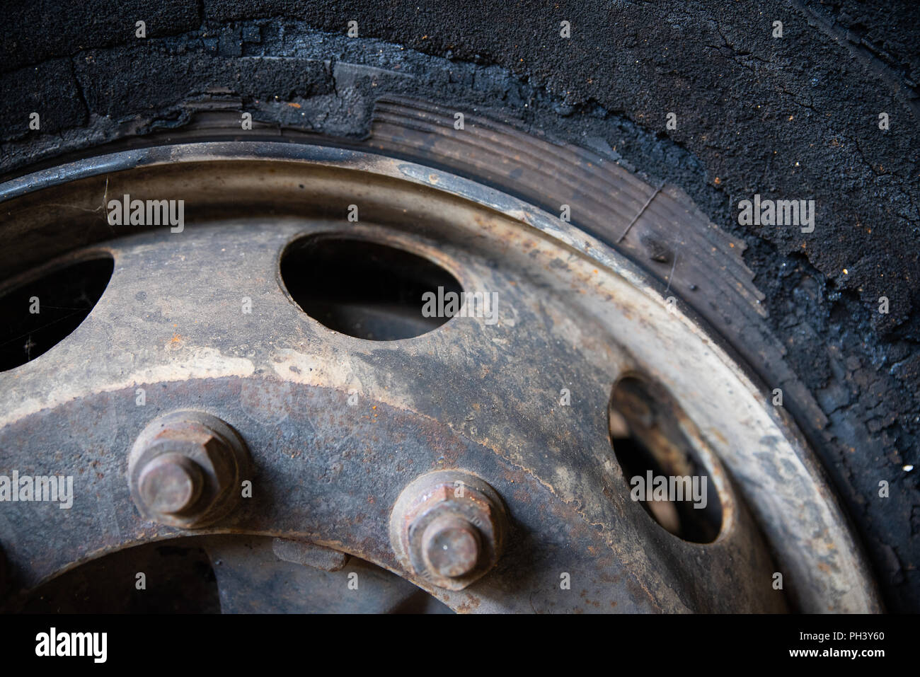 Damaged wheel of burned bus, close up, background Stock Photo