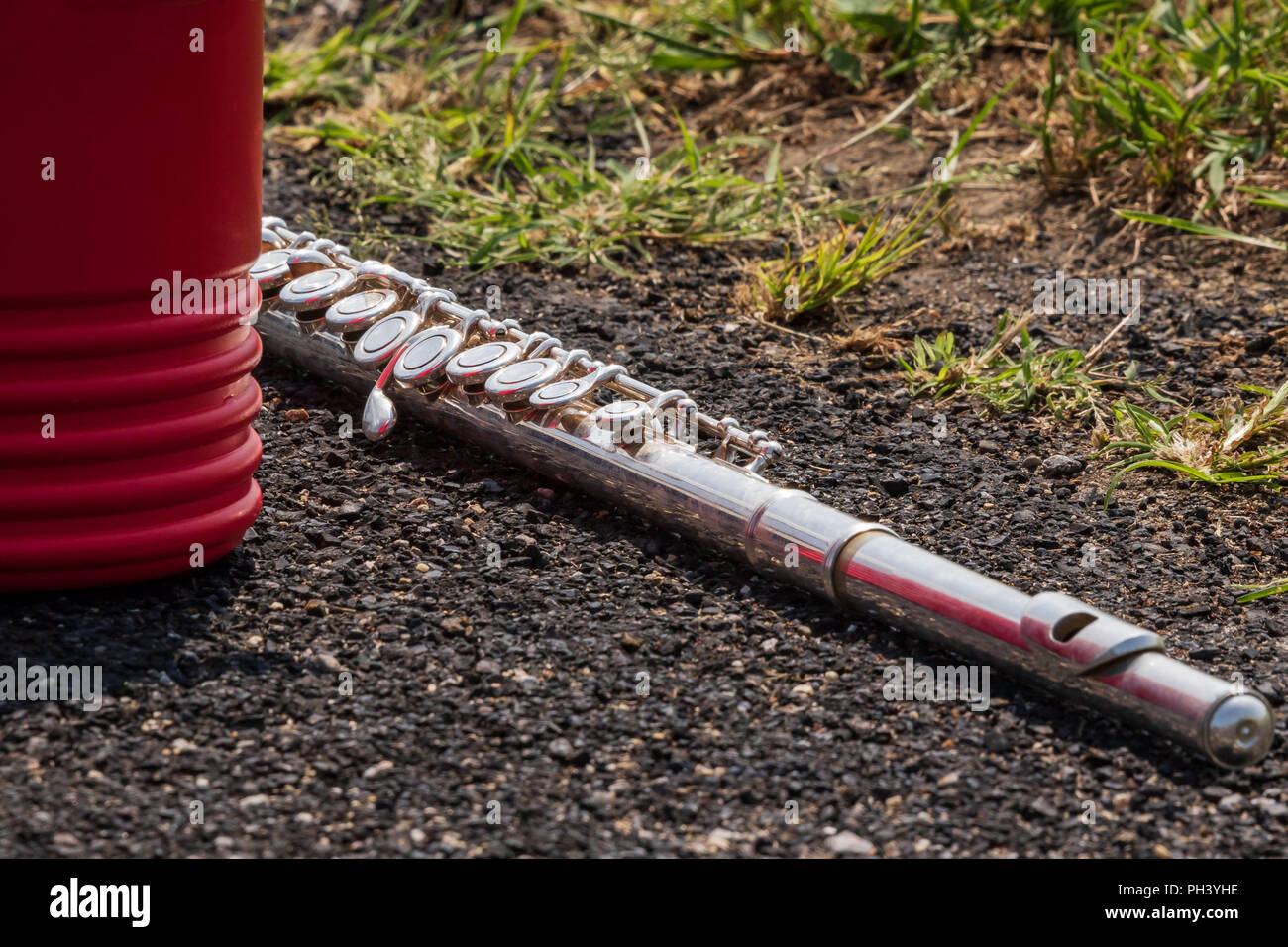 a flute lying on the asphalt track during marching band camp Stock Photo -  Alamy