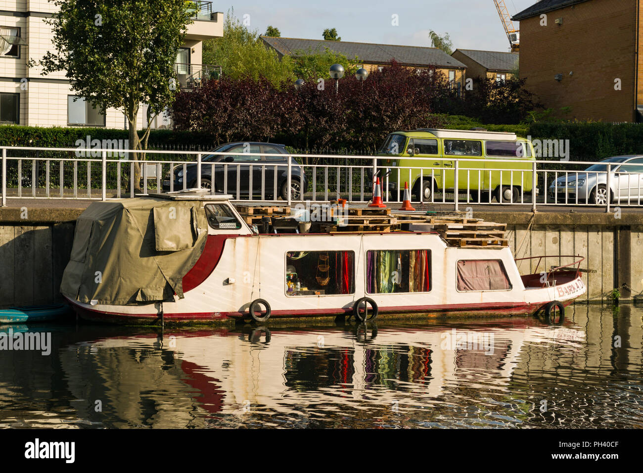 A narrowboat or narrow boat moored on the river Cam, used as long term alternative housing, Cambridge, UK Stock Photo