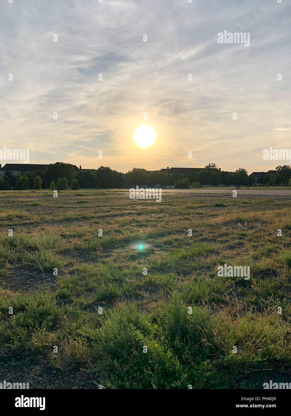 Summer sunset at Tempelhofer Feld, a park at a former airport in Berlin, Germany in 2018. Stock Photo
