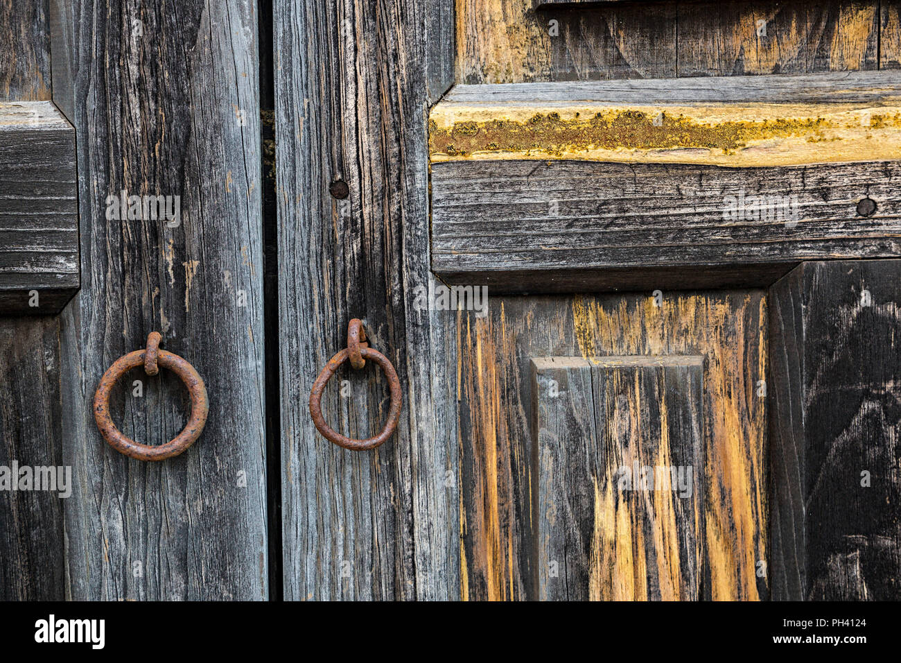 Weathered wooden door with rusty pull ring, Teguise, Lanzarote, Canary Islands, Spain Stock Photo