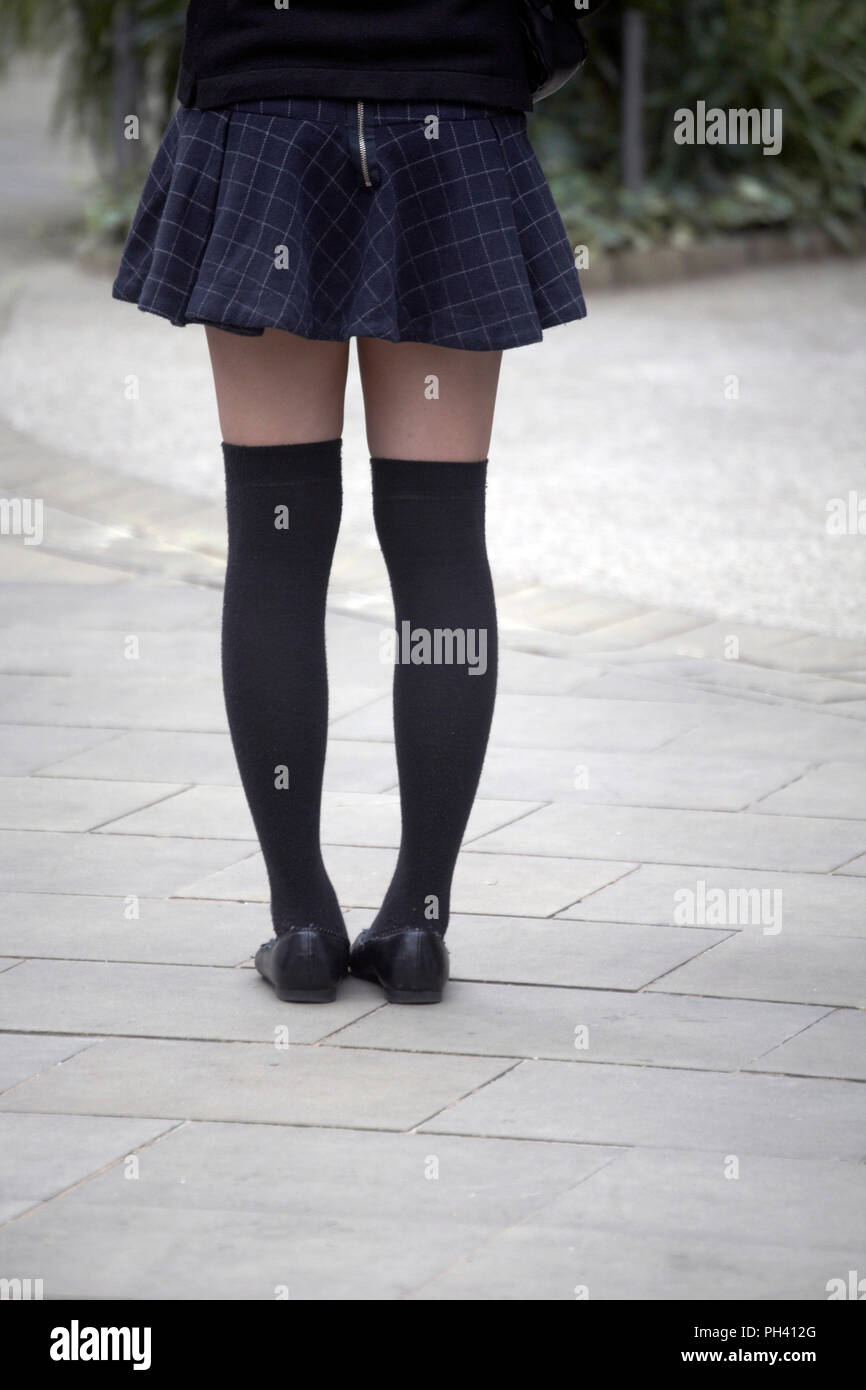 Young girl in mini skirts with over-knee socks, cropped picture from the waist down Stock Photo