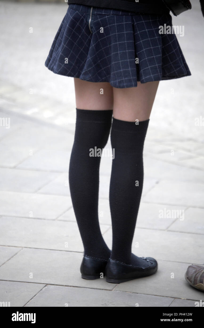 Young girl in mini skirts with over-knee socks, cropped picture from the waist down Stock Photo