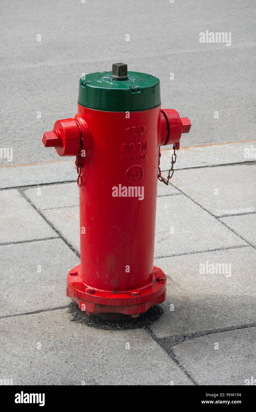 Red and green fire hydrant in Montreal, QC, Canada Stock Photo