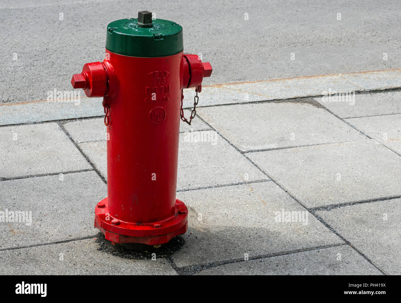 Red and green fire hydrant in Montreal, QC, Canada Stock Photo