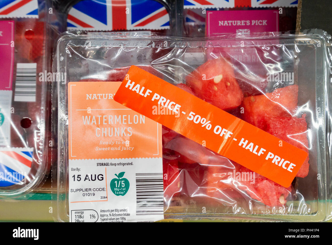 Half price watermelon chunks in plastic container in Aldi supermarket, UK Stock Photo