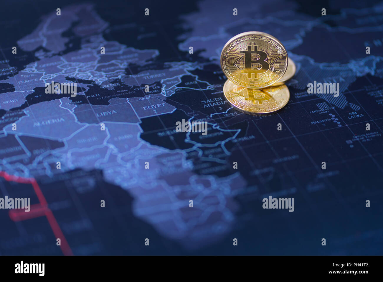 Cryptocurrency coin gold on blurred map world background, Stock Photo