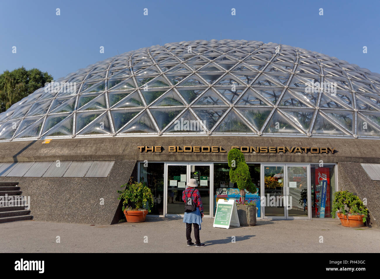 Woman standing at entrance to the Bloedel Conservatory in Queen Elizabeth Park, Vancouver, BC, Canada Stock Photo