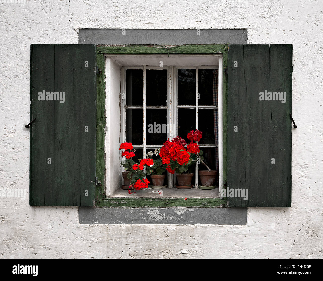 Windows with green wooden shutters and flowers, Schladming, Austria Stock Photo
