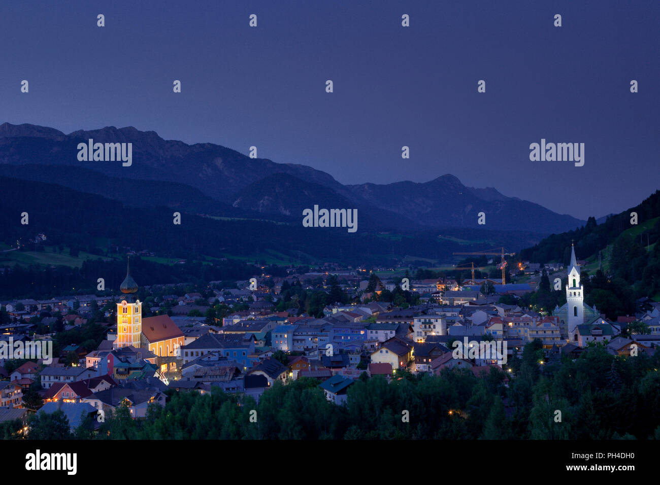 The town of Schladming, Austria, at dusk, set against the Dachstein Mountains Stock Photo