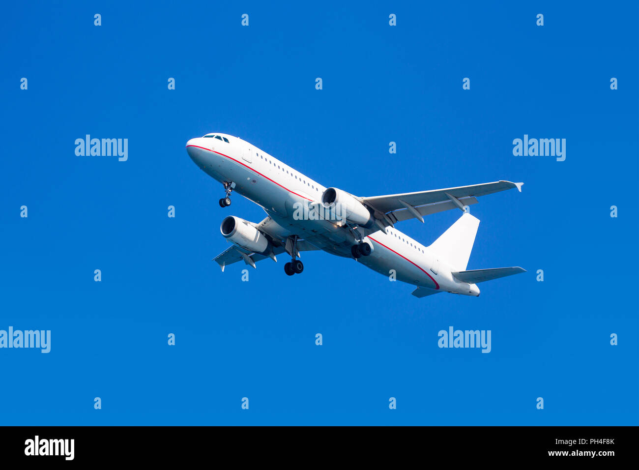 Airplane on a blue sky background Stock Photo - Alamy