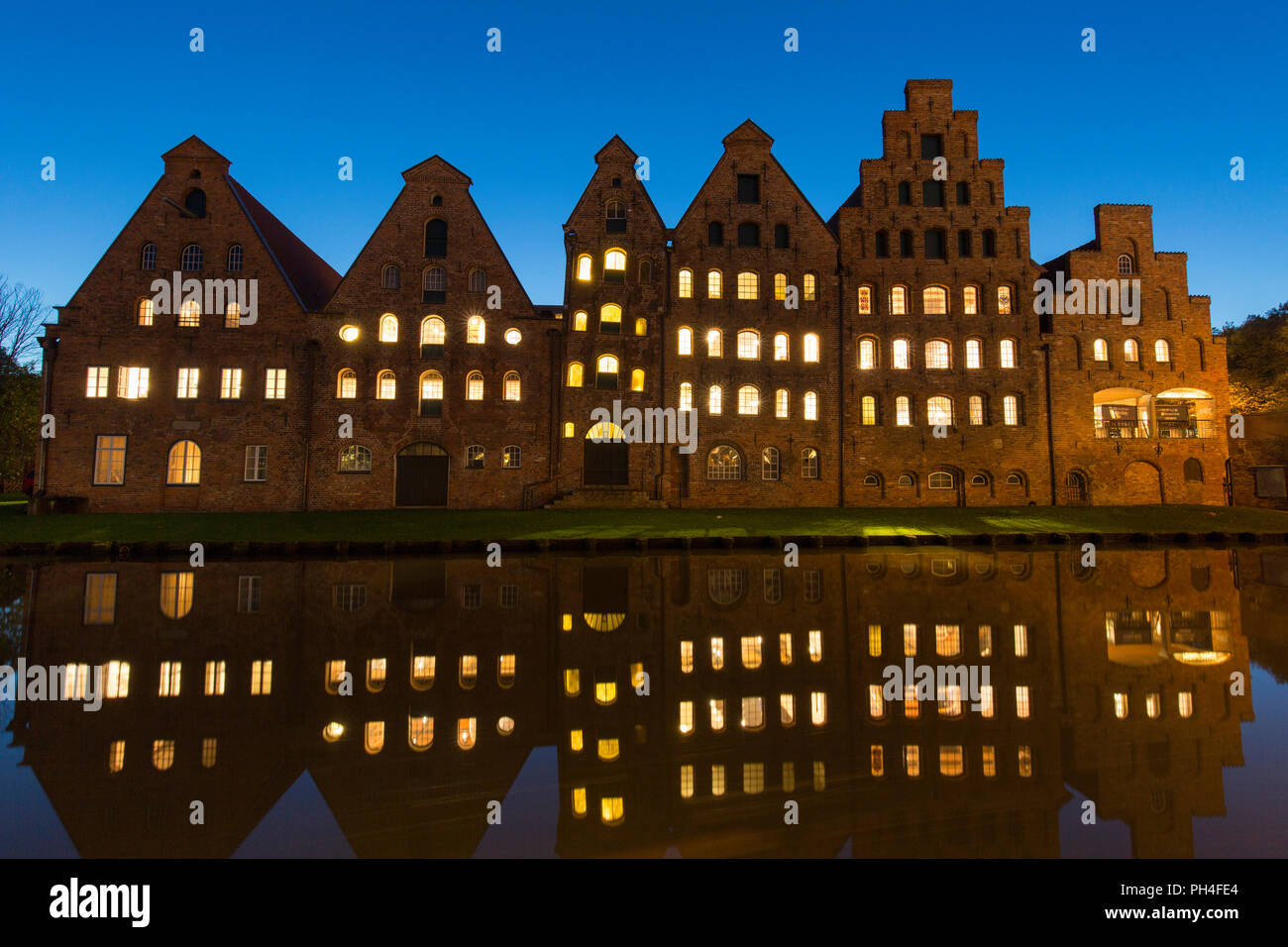Historic salt storehouses (Salzspeicher) on the river Trave in Luebeck, Schleswig-Holstein, Germany at night Stock Photo