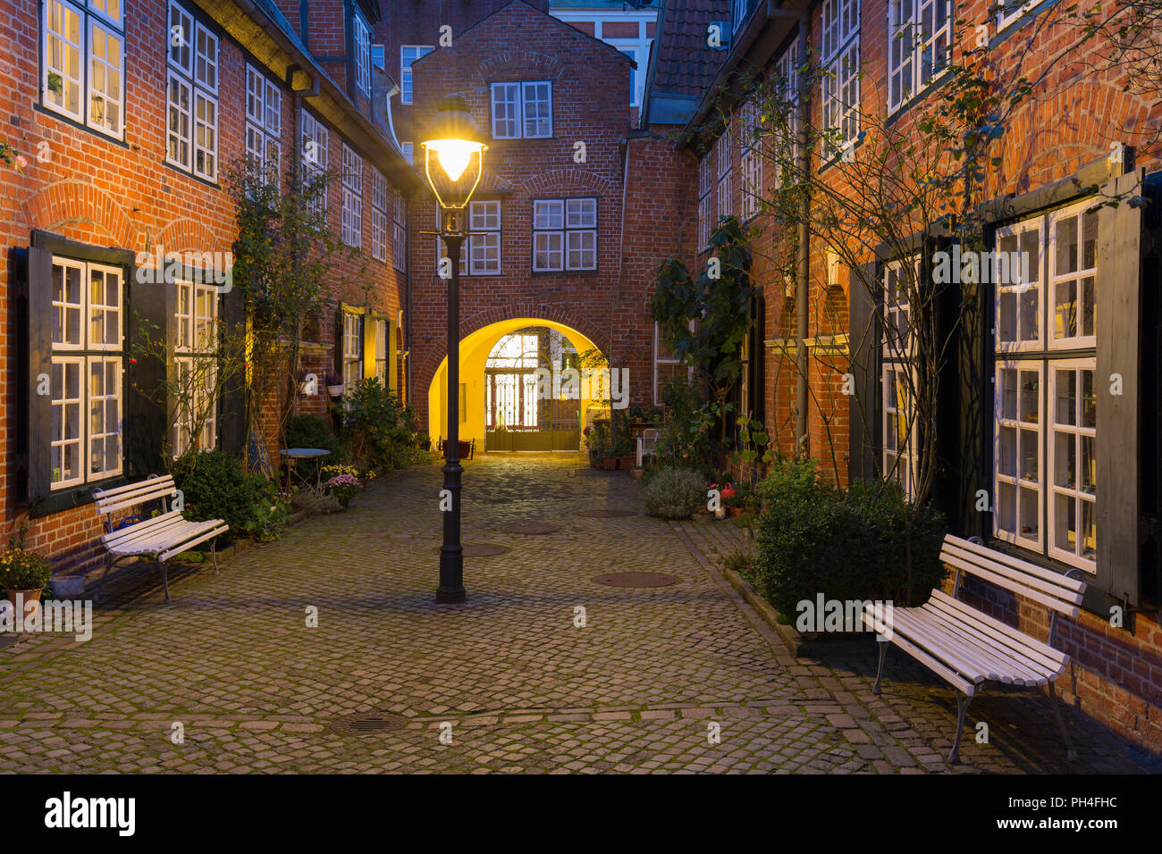 The Haasenhof yard is the youngest of the foundation courts in Luebeck, Schleswig-Holstein, Deutschland, seen at night Stock Photo