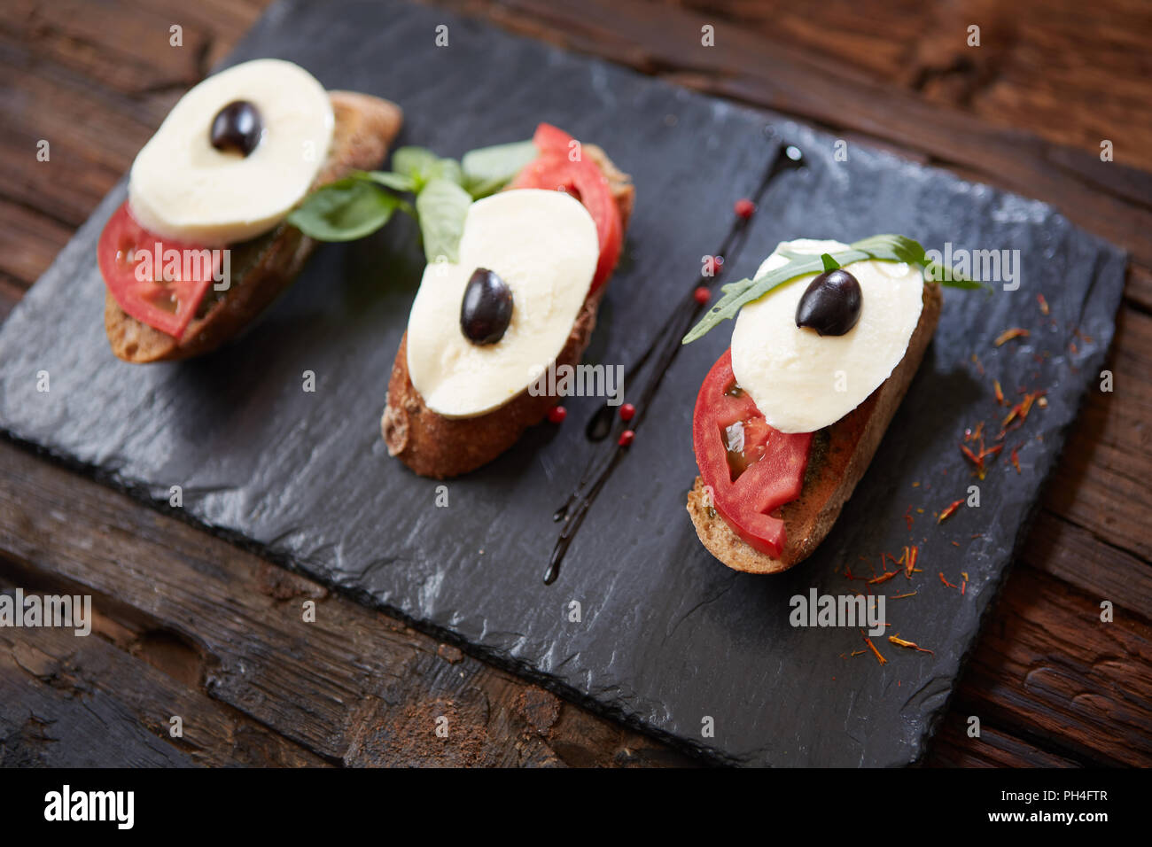Italian bruschetta with chopped tomatoes, basil, mozzarella cheese and