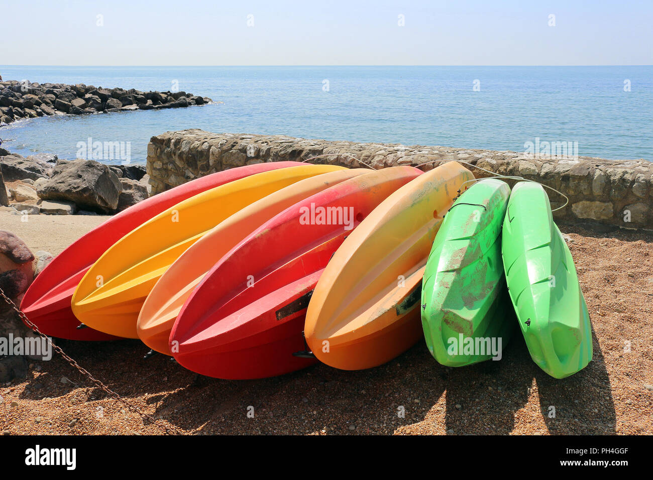 Colourful kayaks on shore at the beach Stock Photo - Alamy