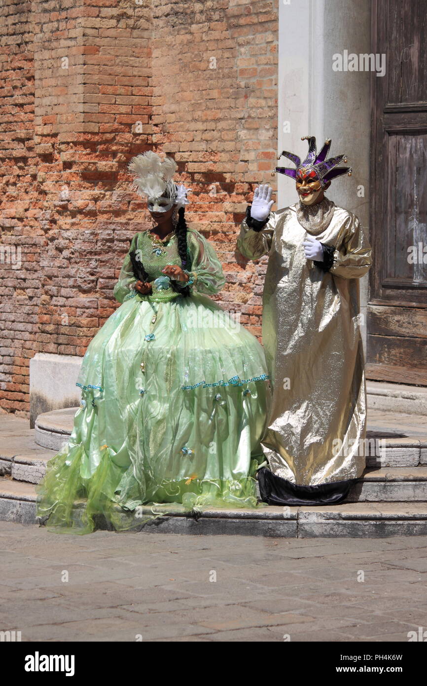 Venice, Italy - August 4, 2012: Two people in Venetian costume in the downtown of Venice, Italy Stock Photo