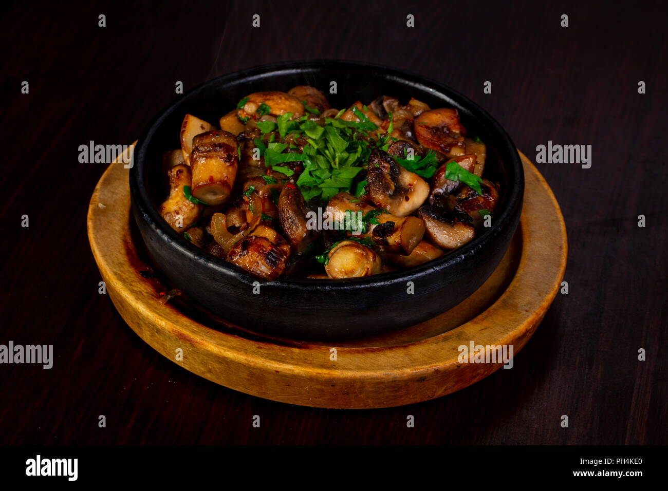 Roasted mushrooms in the pan with herbs Stock Photo - Alamy