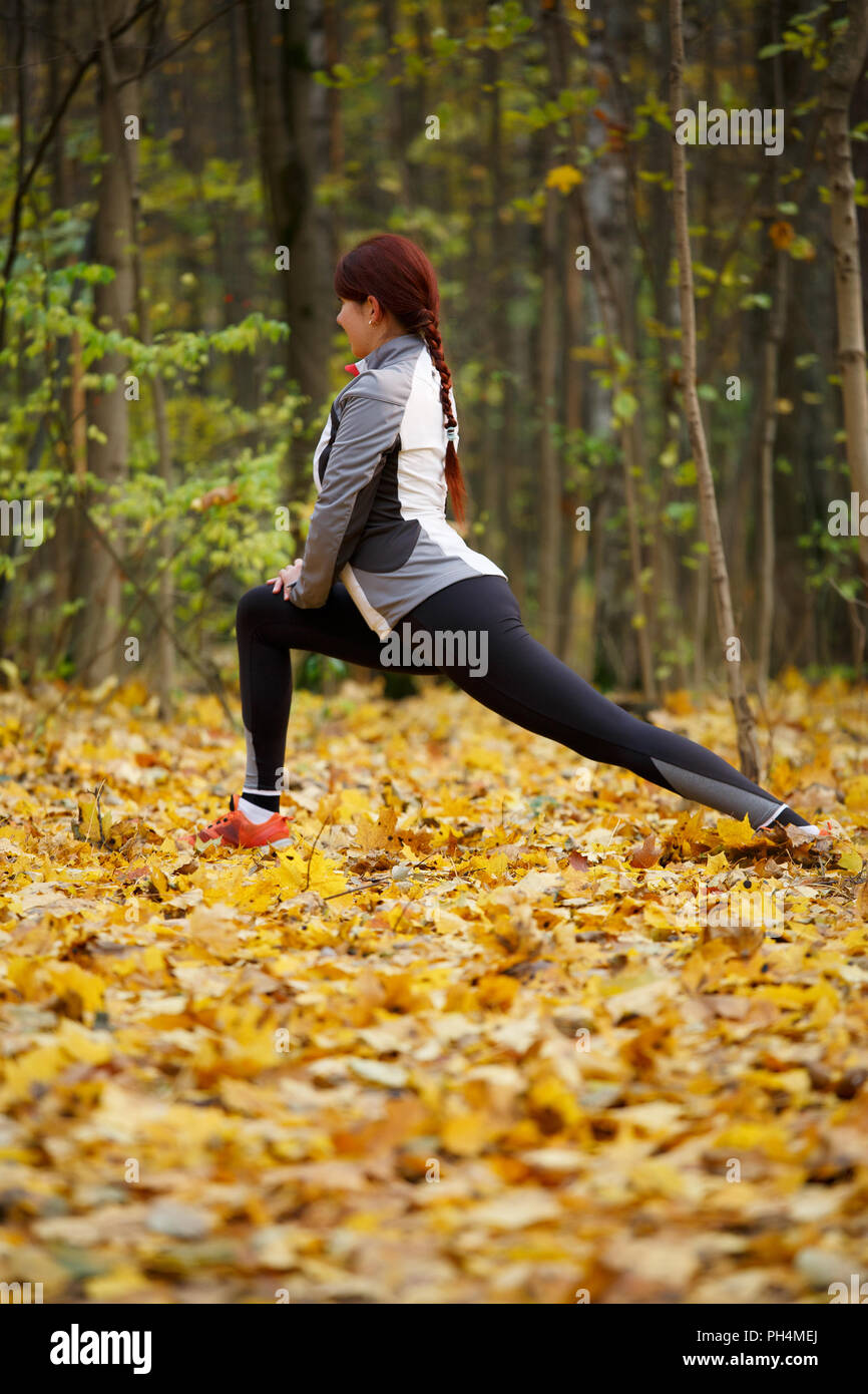 Woman stretching in woods hi-res stock photography and images - Alamy
