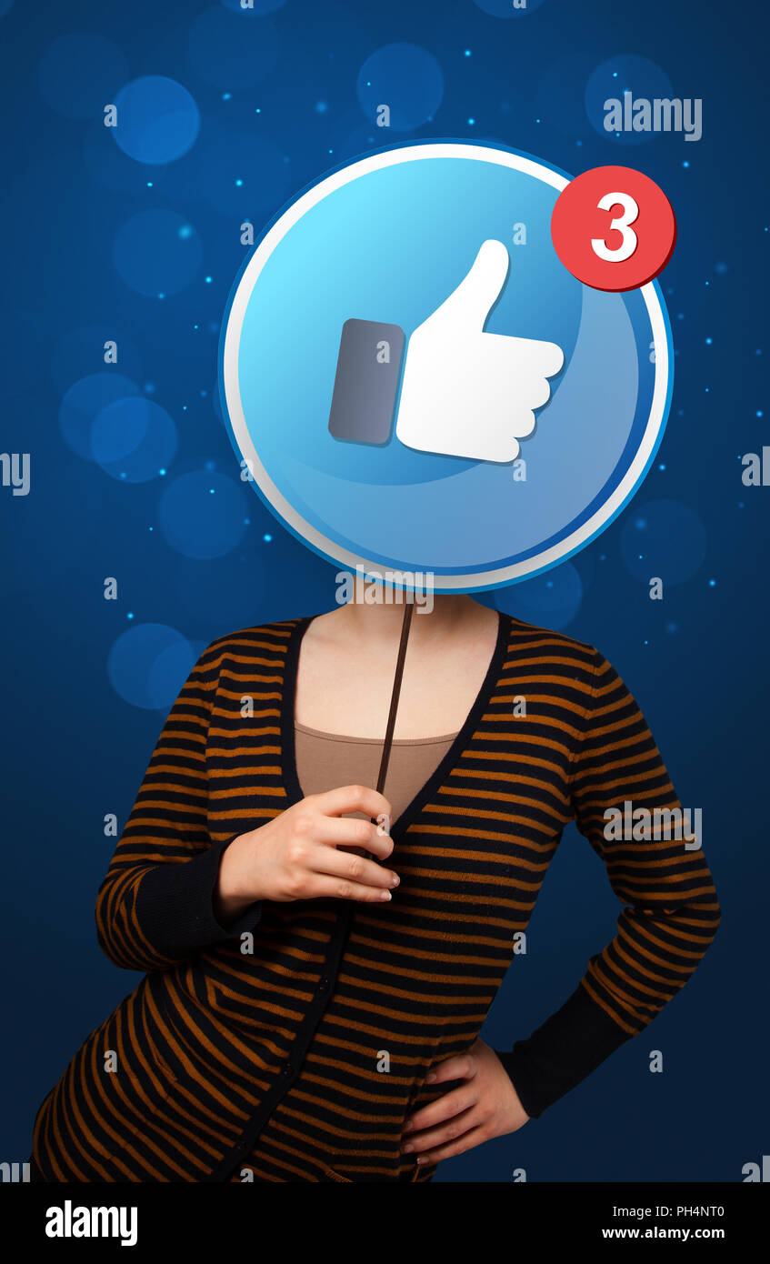 Casual young woman holding round sign with facebook like Stock Photo