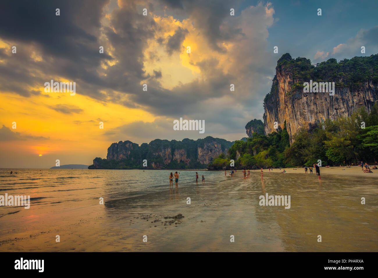 Tourists rest at the Railay Beach before sunset Stock Photo