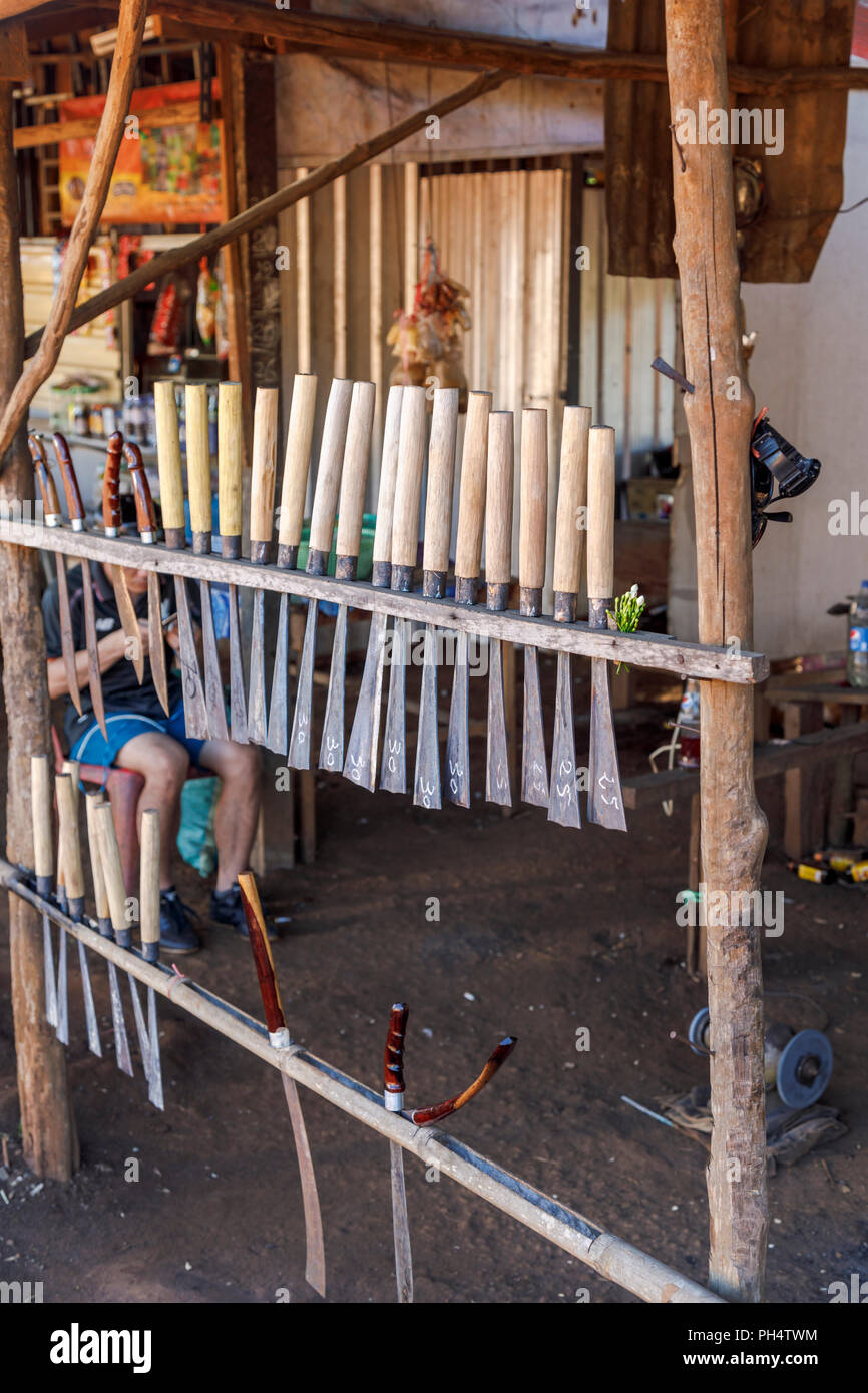 Display of knives and machetes in a roadside stall in Houayhe, a