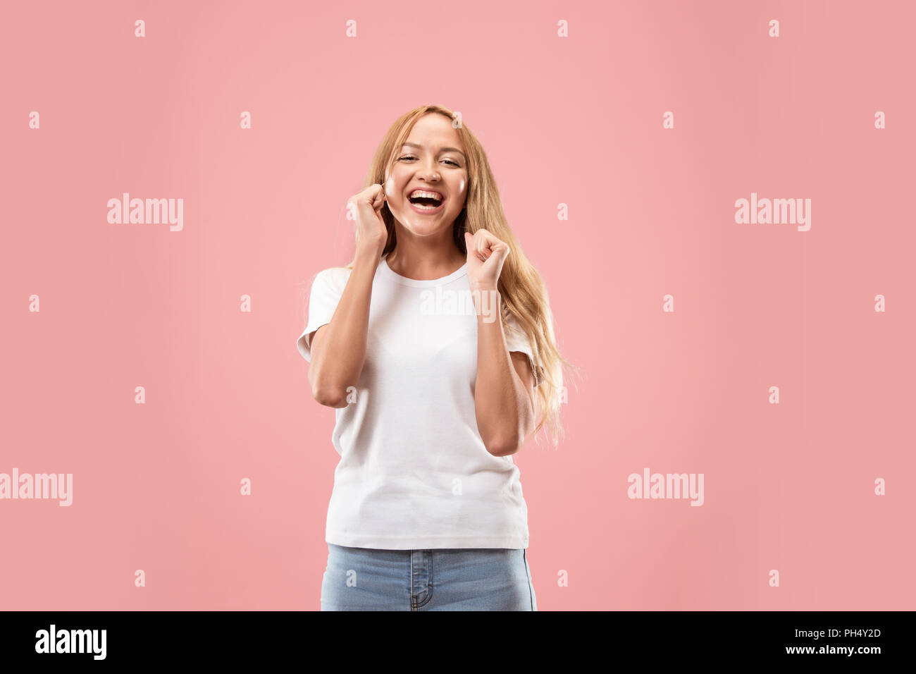 I won. Winning success happy woman celebrating being a winner. Dynamic image of caucasian female model on studio background. Victory, delight concept. Human facial emotions concept. Trendy colors Stock Photo