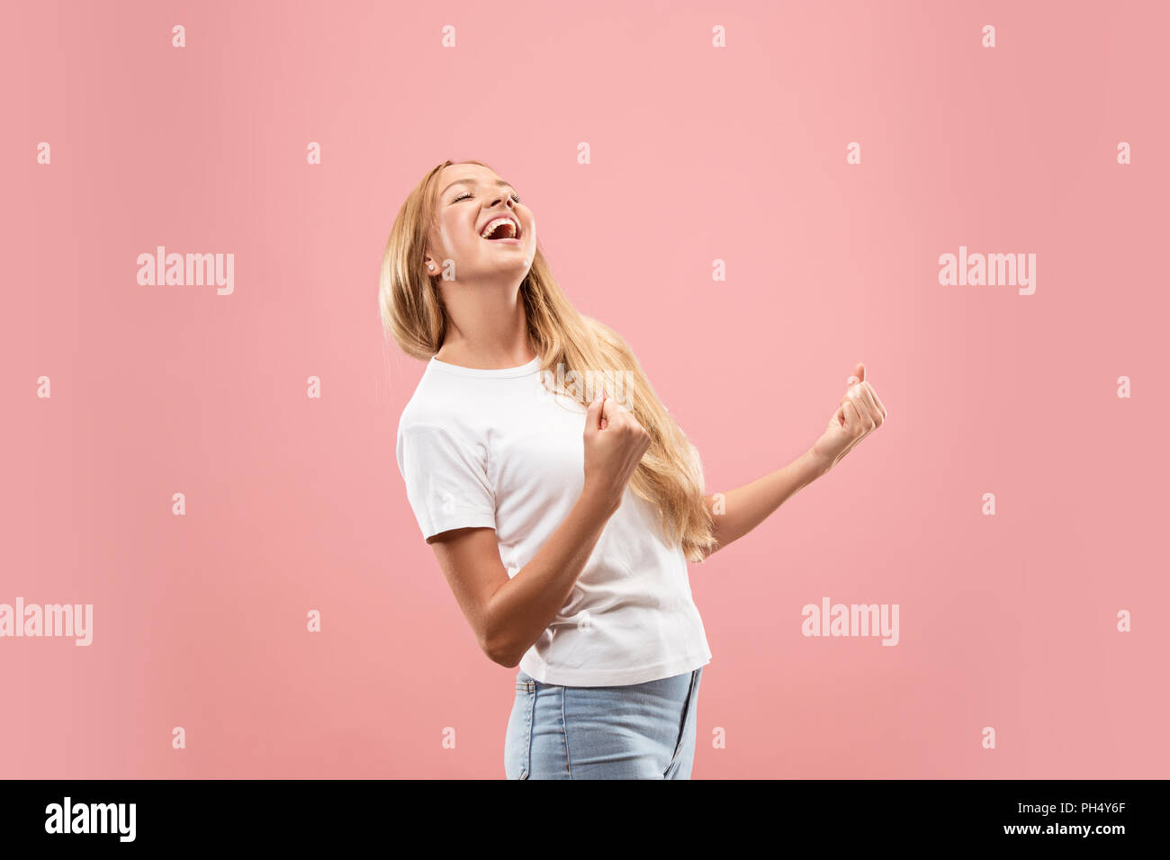 I won. Winning success happy woman celebrating being a winner. Dynamic image of caucasian female model on studio background. Victory, delight concept. Human facial emotions concept. Trendy colors Stock Photo