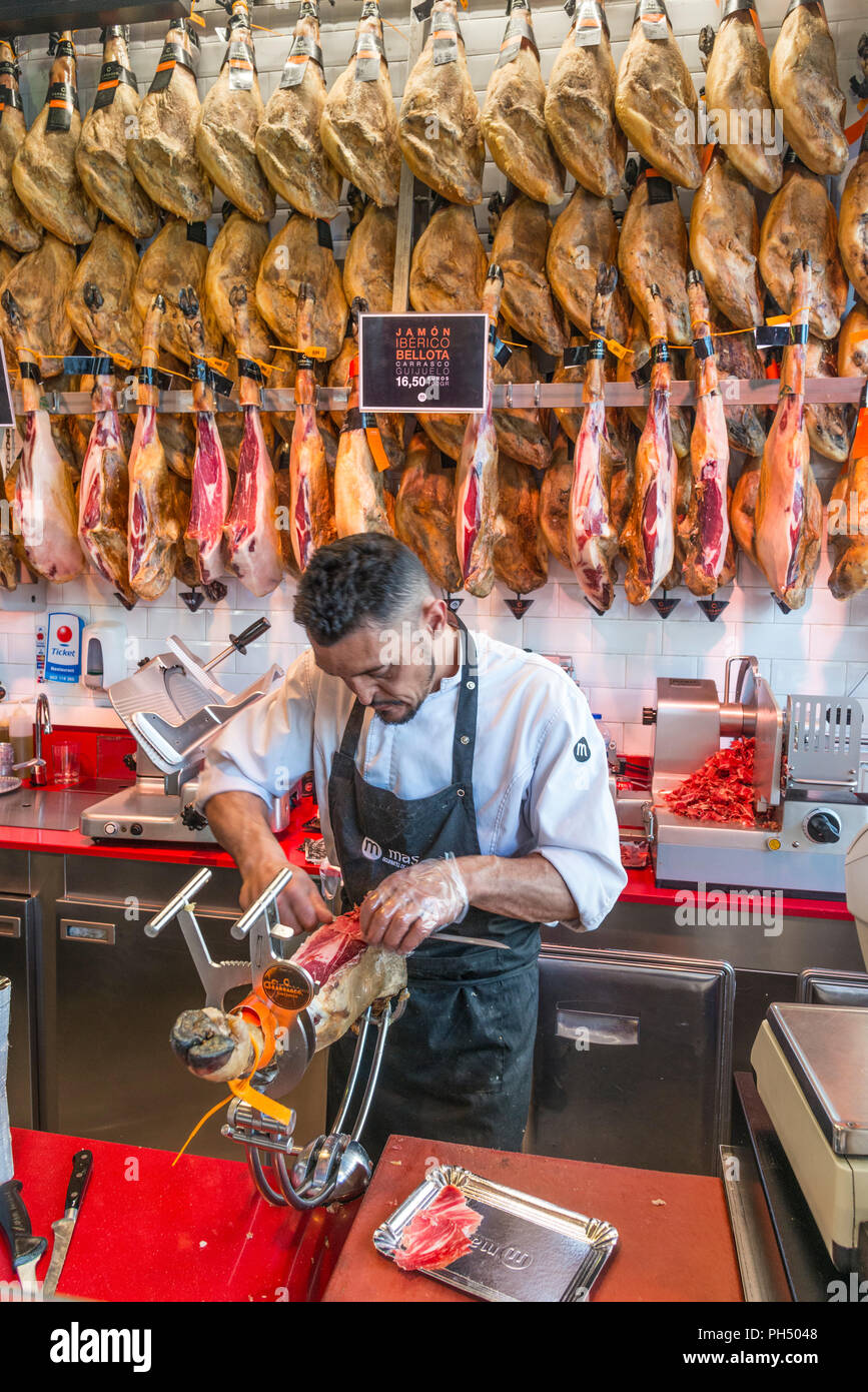 Jamon Iberico de Bellota, Spanish cured hams for sale in the Mercado de San Miguel, Madrid, Spain Stock Photo