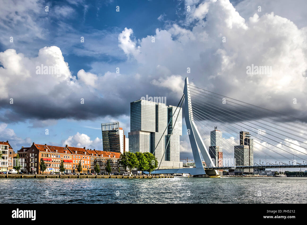 Rotterdam, The Netherlands, August 13, 2018: view from the river towards Erasmus Bridge, Noordereiland neighbourhood and De Rotterdam building Stock Photo