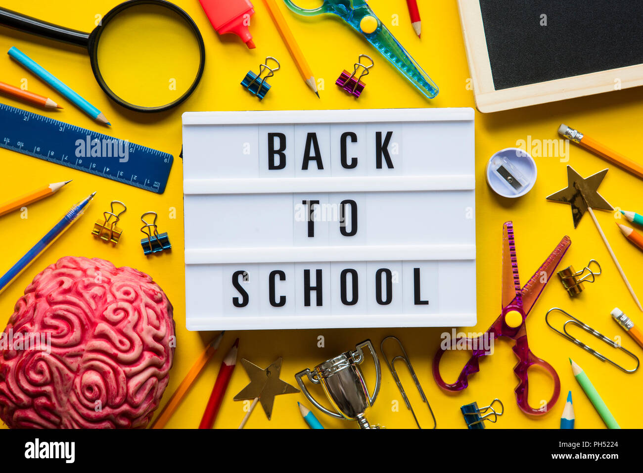 Back to school lightbox message on a bright yellow background Stock Photo