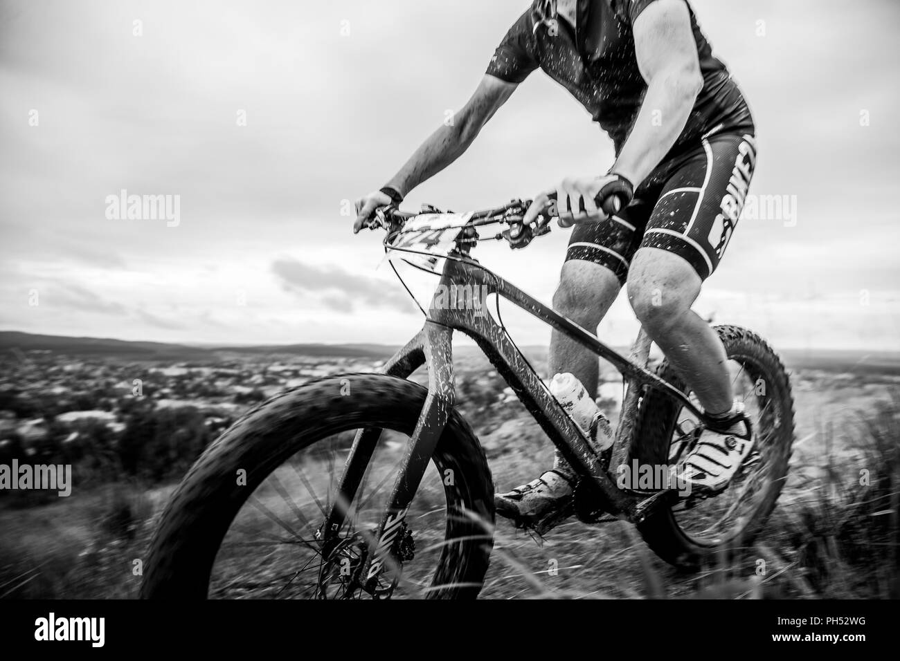 V.Ufaley, Russia - August 12, 2018: racer cyclist mountain biker in mud spray during race XCM Big stone Stock Photo