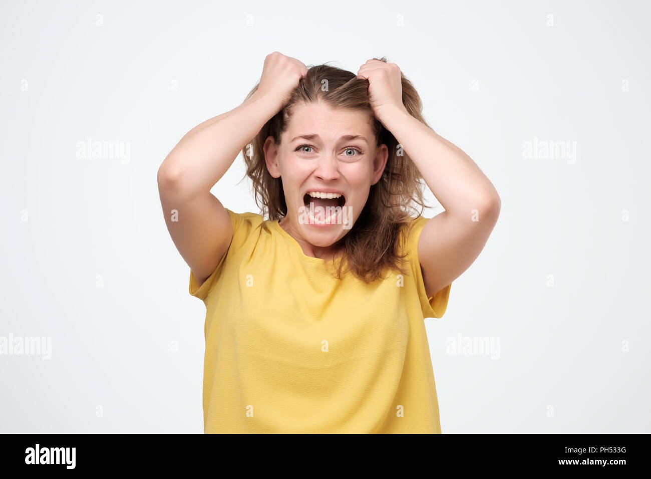 Closeup portrait stressed, frustrated shocked woman pulling hair out