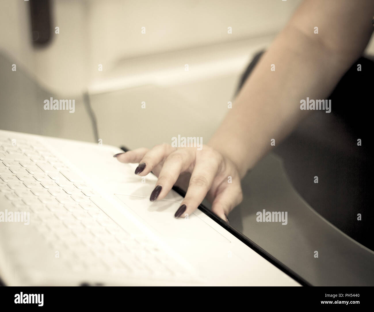 Womans hand on white computer keyboard. Copy space Stock Photo
