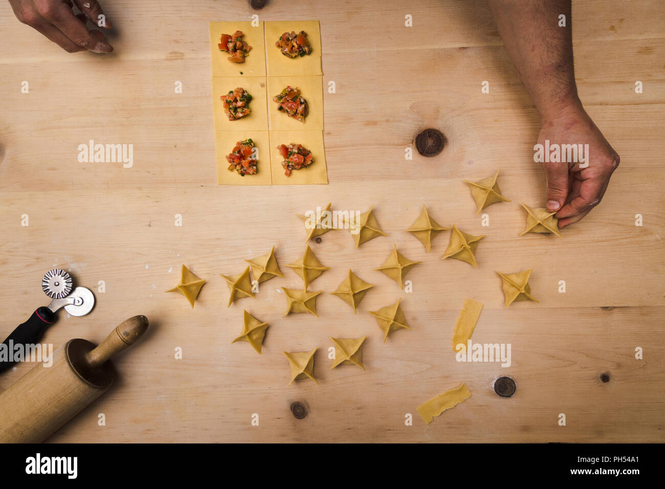 Overhead shot of chefs hands making fresh ravioli pasta Stock Photo - Alamy