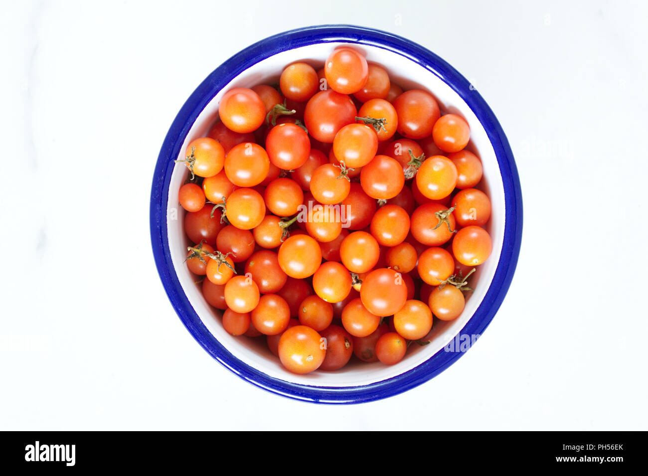 Lycopersicon esculentum.Tomato 'Cherry Cascade' in an enamel bowl. Stock Photo