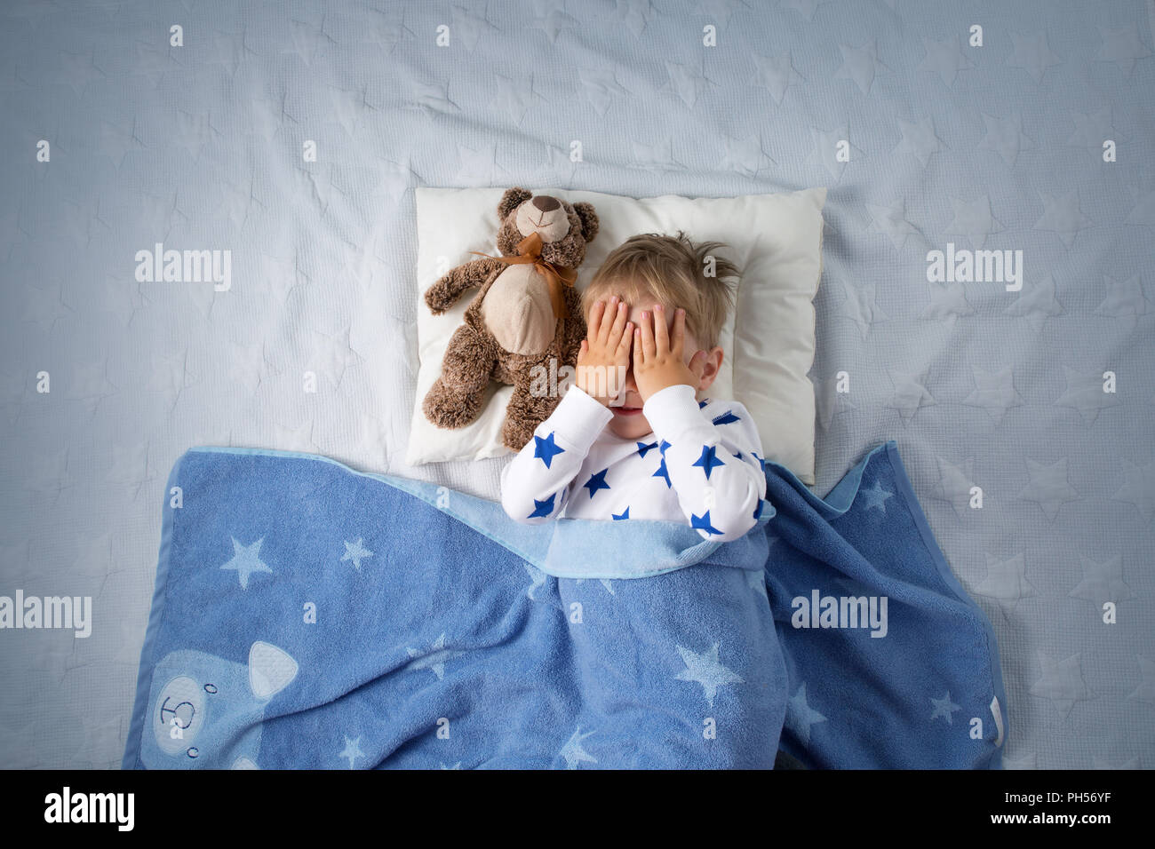 Three years old child crying in bed Stock Photo