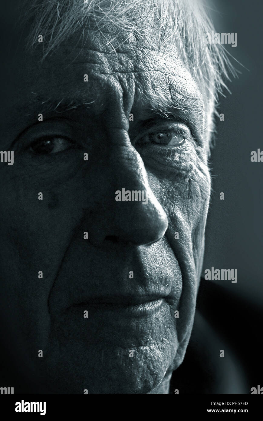 strong graphic side lit portait of older man Stock Photo