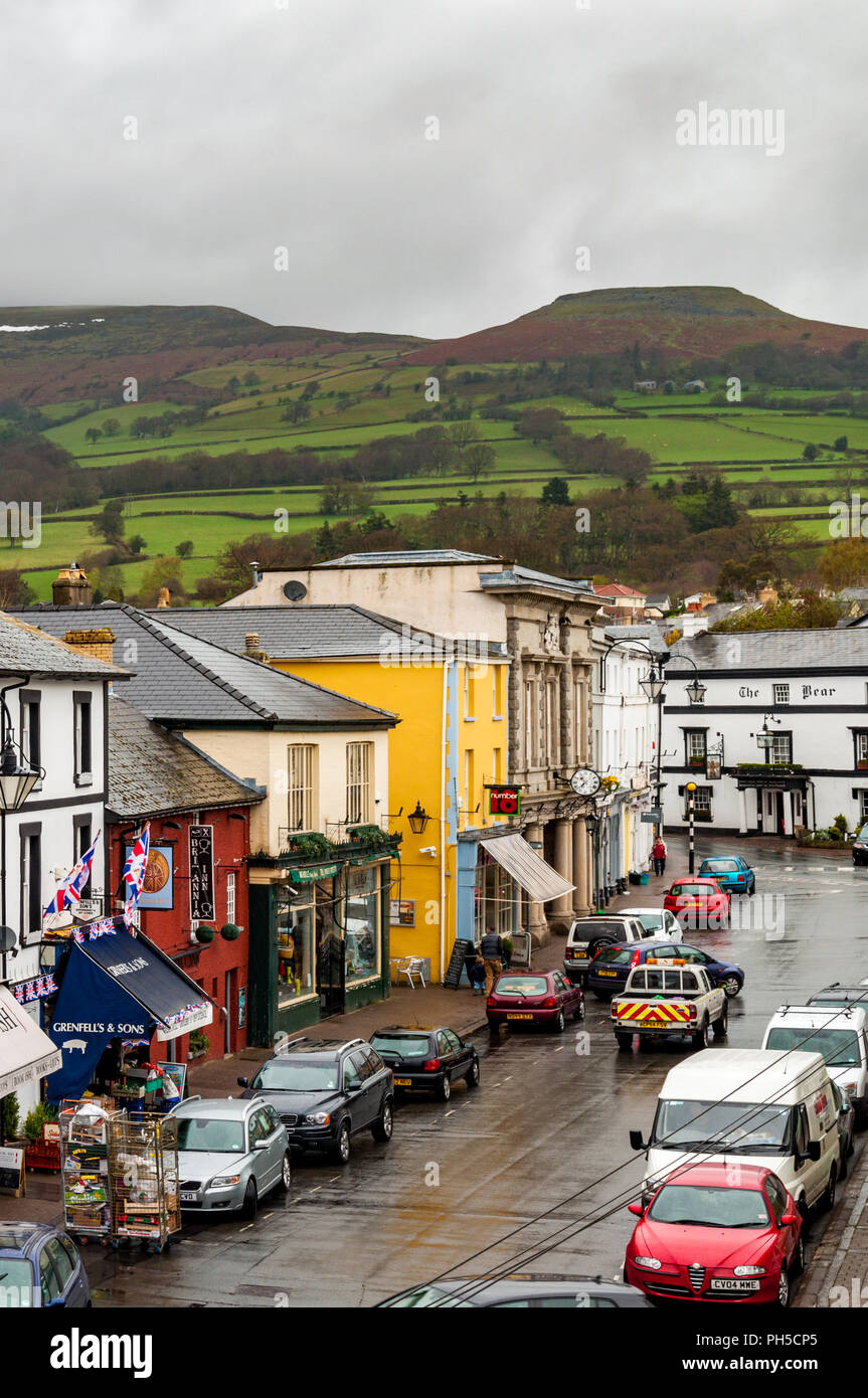 Crickhowell High Street showing The Bear Hotel with the Brecon Beacons behind, Powys, Wales Stock Photo