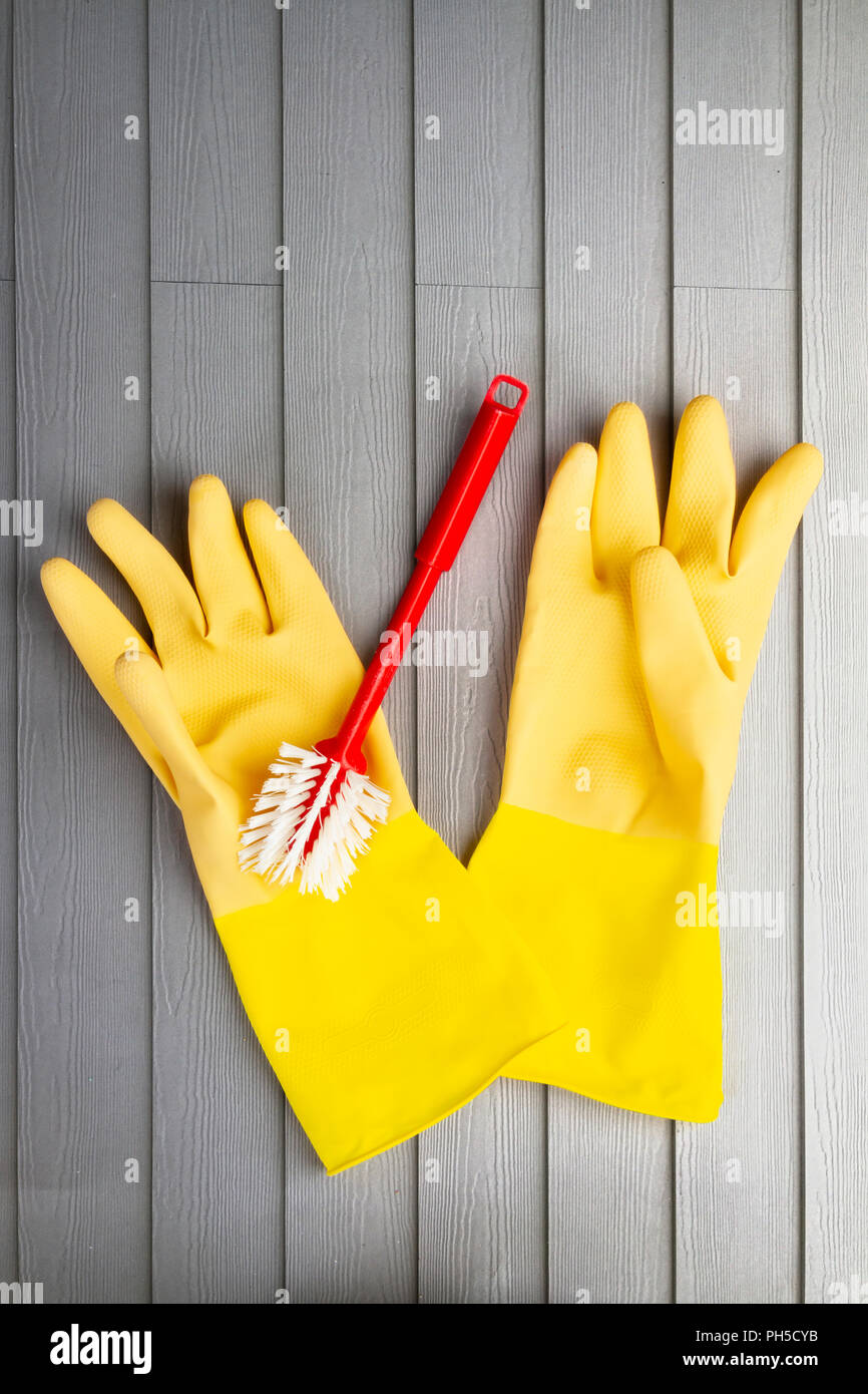 Yellow rubber gloves and washing up brush Stock Photo