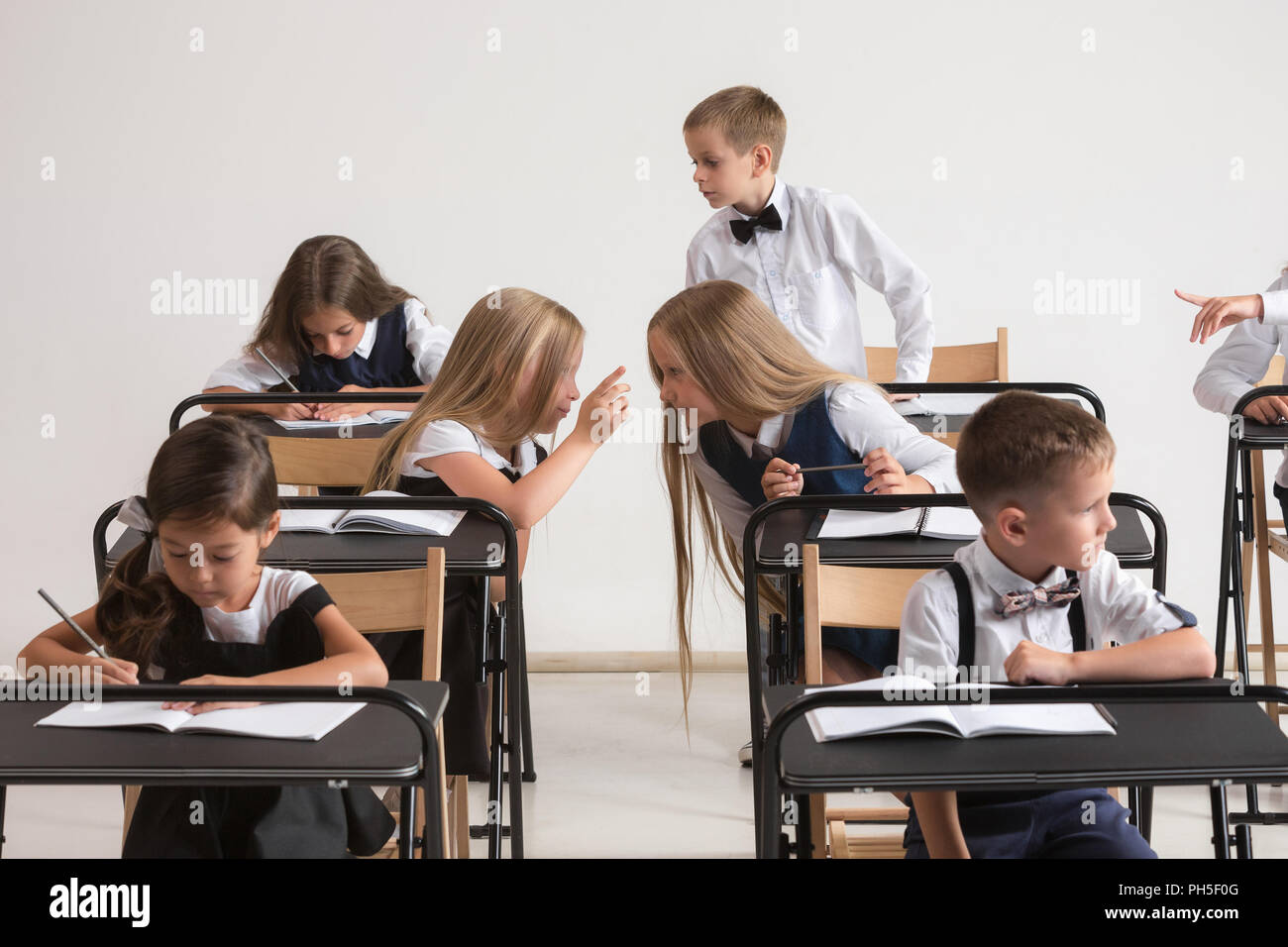 School Children In Classroom At Lesson The Little Boys And Girls