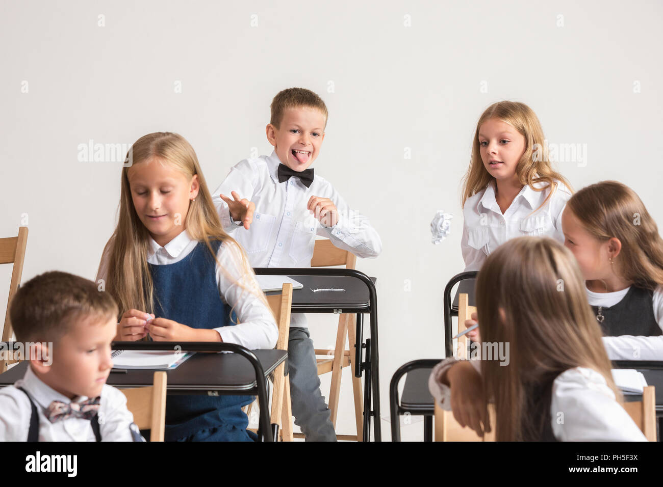 School Children In Classroom At Lesson The Little Boys And Girls