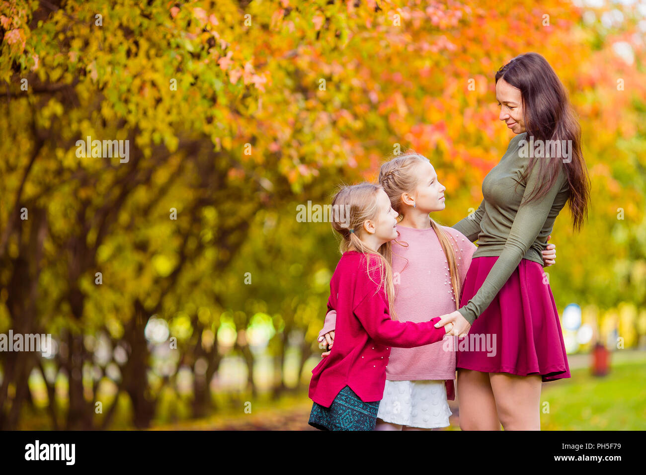 Little girl with mom outdoors in park at autumn day Stock Photo - Alamy